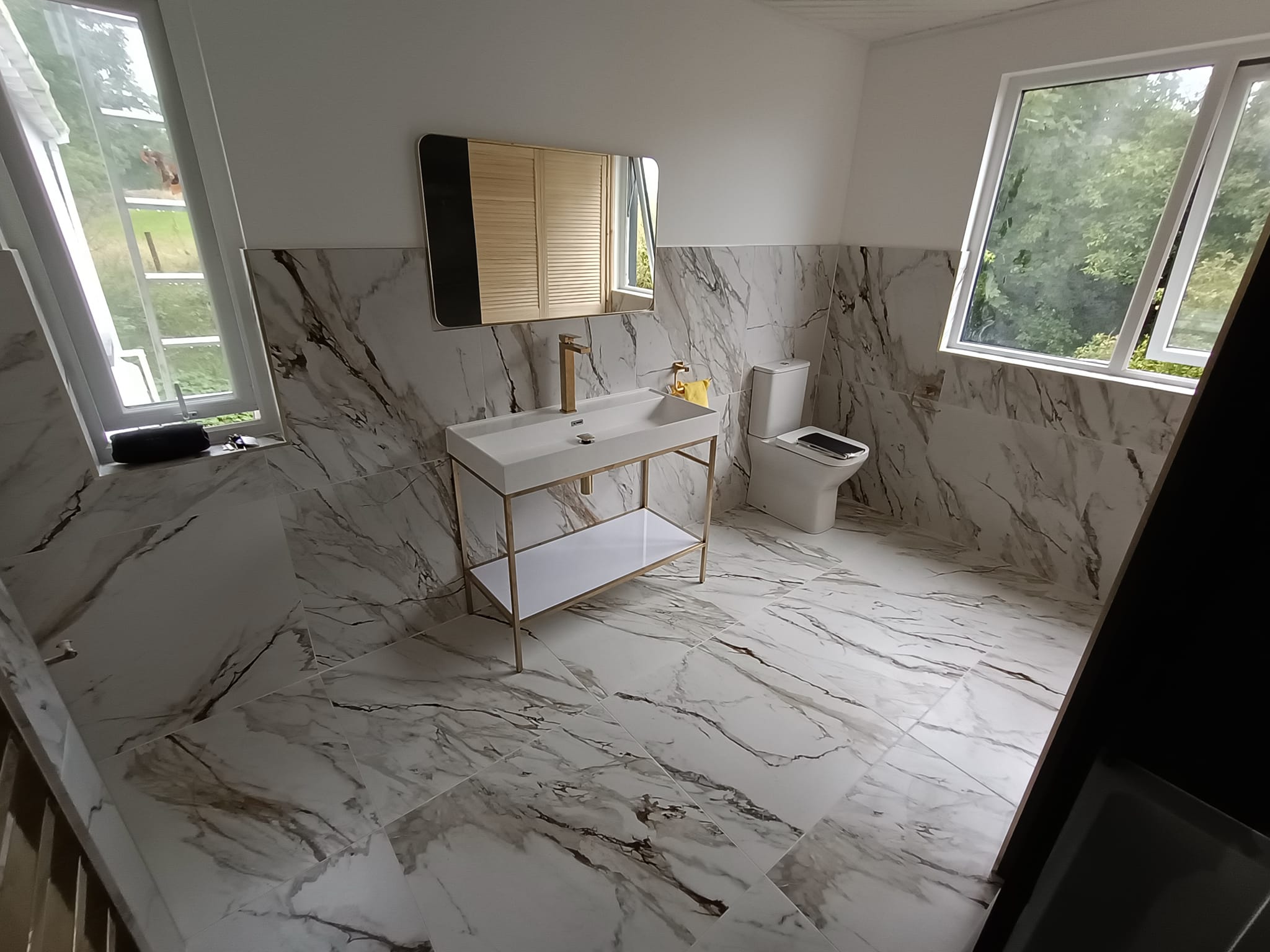 marble bathroom with gold accents