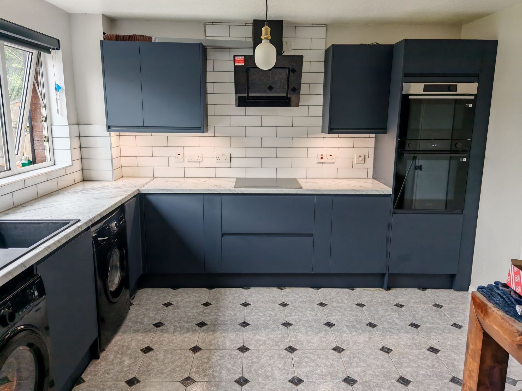Navy kitchen with marble countertops