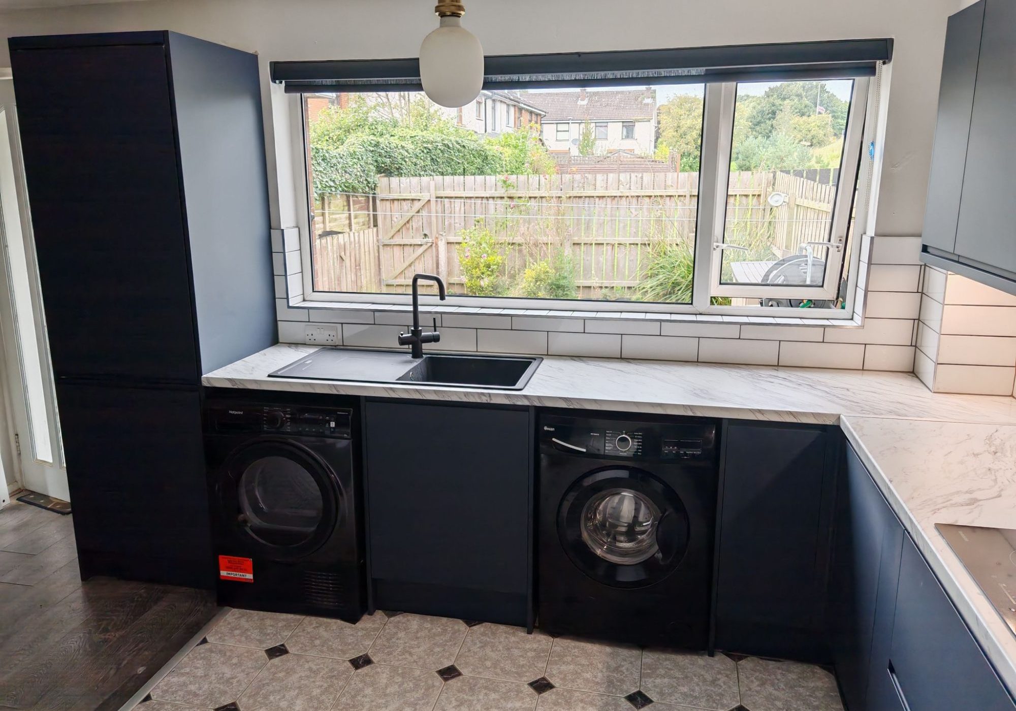 Navy kitchen with black appliances