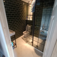 Small bathroom with green tiled walls