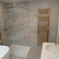 Patterned tiled bathroom with gold hardware