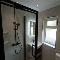 stone effect tiles with black shower