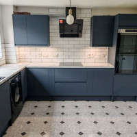 Navy kitchen with marble countertops